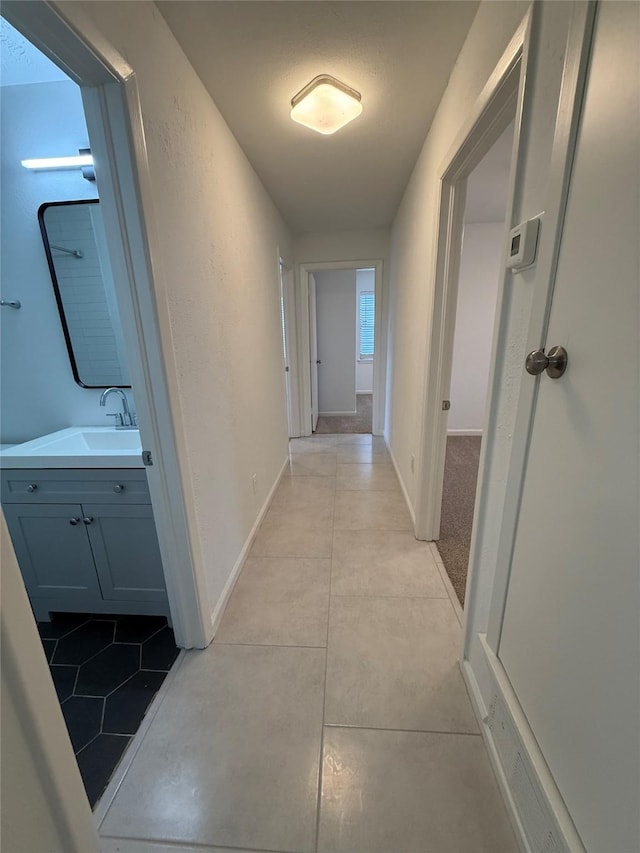 1833 Hood St, Carrollton, TX 75006 - corridor with a sink and light tile patterned floors