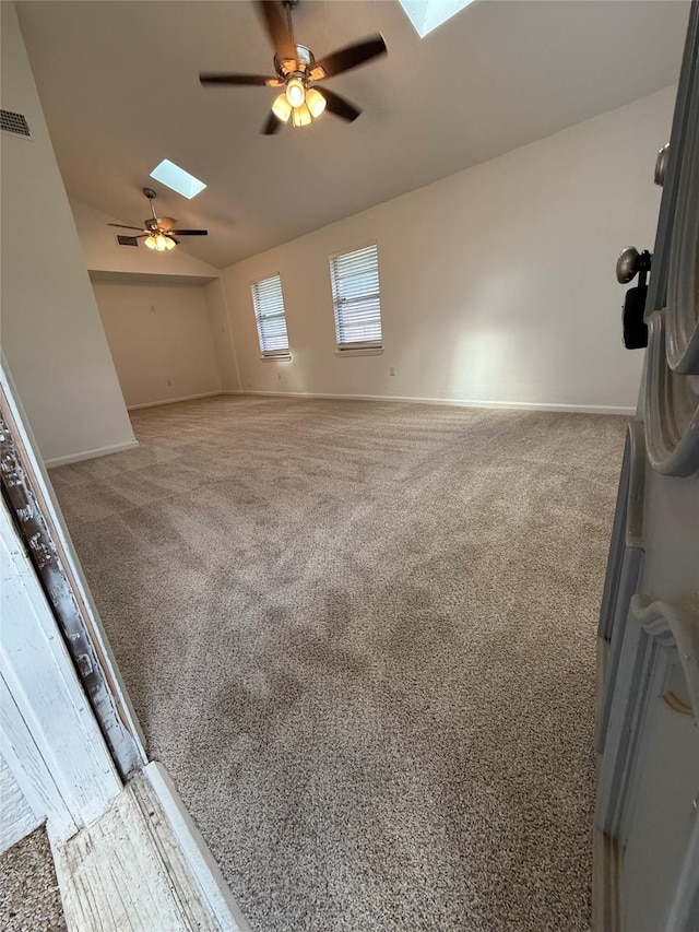 1833 Hood St, Carrollton, TX 75006 - empty room featuring a skylight, a ceiling fan, vaulted ceiling, carpet, and baseboards