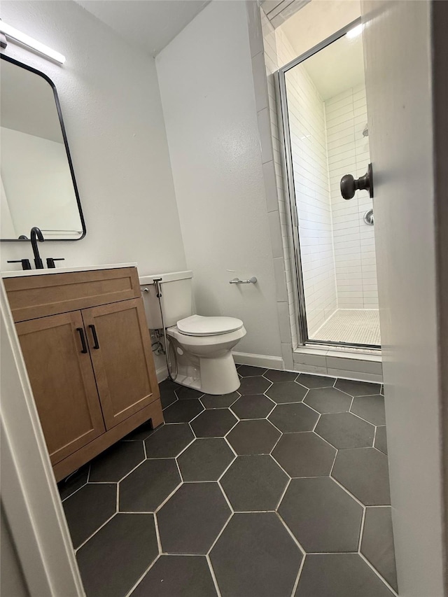 1833 Hood St, Carrollton, TX 75006 - full bath with a stall shower, vanity, toilet, tile patterned floors, and baseboards
