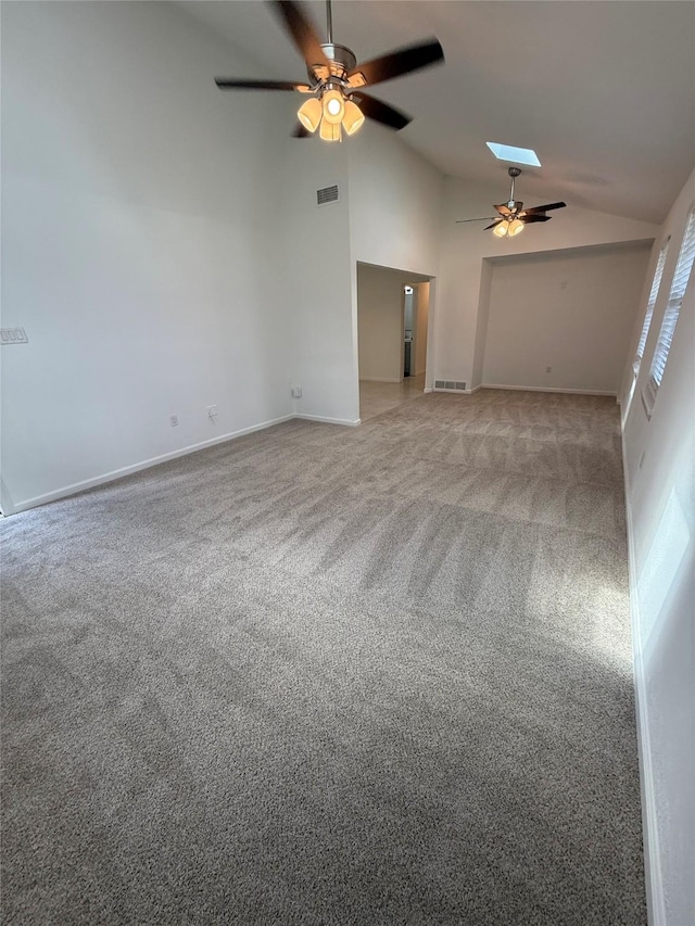 1833 Hood St, Carrollton, TX 75006 - unfurnished living room featuring a ceiling fan, lofted ceiling, light colored carpet, baseboards, and a skylight
