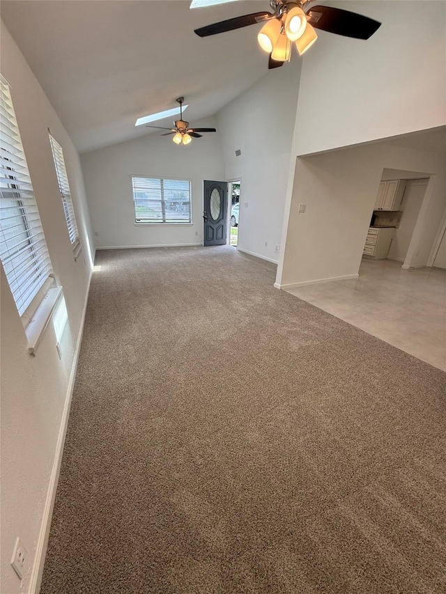 1833 Hood St, Carrollton, TX 75006 - unfurnished living room with a ceiling fan, baseboards, high vaulted ceiling, and light colored carpet