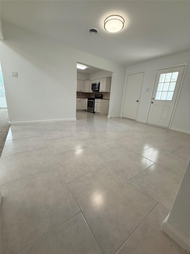1833 Hood St, Carrollton, TX 75006 - unfurnished living room with baseboards and light tile patterned flooring