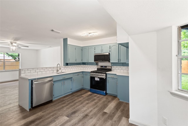 3812 David Ln, Forest Hill, TX 76119 - kitchen with appliances with stainless steel finishes, a peninsula, tasteful backsplash, and healthy amount of natural light