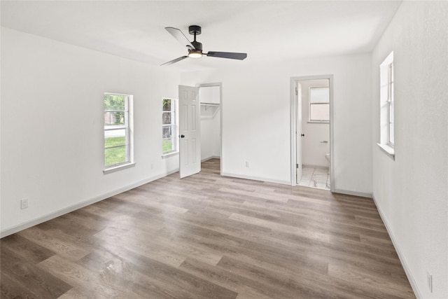 3812 David Ln, Forest Hill, TX 76119 - unfurnished bedroom with wood finished floors, baseboards, ensuite bath, and a walk in closet
