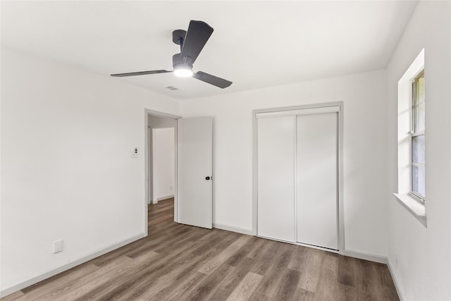 3812 David Ln, Forest Hill, TX 76119 - unfurnished bedroom featuring wood finished floors, a closet, a ceiling fan, and baseboards