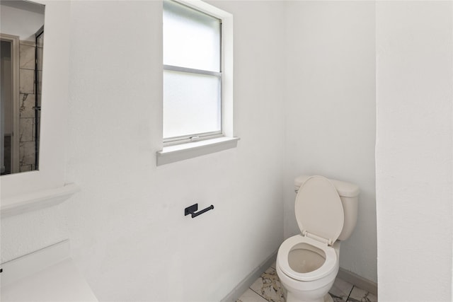 3812 David Ln, Forest Hill, TX 76119 - bathroom with toilet, baseboards, and marble look tiles
