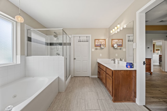 1329 E Highland Rd, Waxahachie, TX 75167 - bathroom with vanity, a whirlpool tub, a shower stall, and wood finished floors
