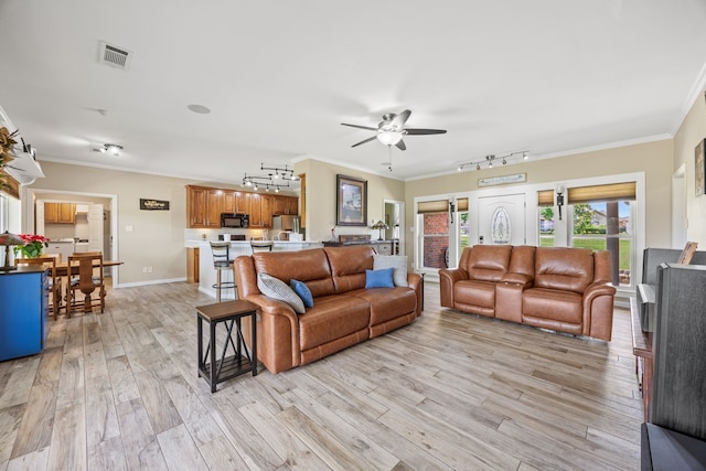 1329 E Highland Rd, Waxahachie, TX 75167 - living room featuring rail lighting, a ceiling fan, light wood finished floors, crown molding, and baseboards