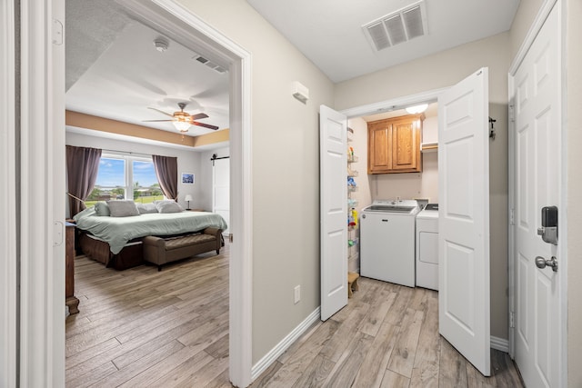 1329 E Highland Rd, Waxahachie, TX 75167 - washroom with cabinet space, washing machine and clothes dryer, light wood-style flooring, ceiling fan, and baseboards