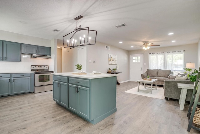 1909 Balla Way, Grand Prairie, TX 75051 - kitchen with electric range, light wood-style floors, under cabinet range hood, decorative backsplash, and recessed lighting