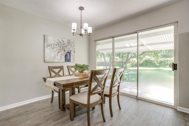 1909 Balla Way, Grand Prairie, TX 75051 - dining room featuring a chandelier, wood finished floors, and baseboards