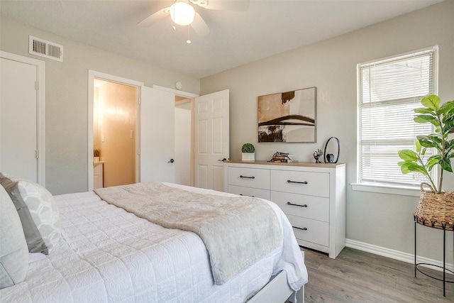 1909 Balla Way, Grand Prairie, TX 75051 - bedroom featuring light wood finished floors, baseboards, a ceiling fan, and connected bathroom