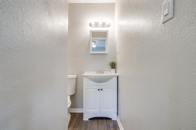 1909 Balla Way, Grand Prairie, TX 75051 - bathroom featuring vanity, toilet, wood finished floors, a textured wall, and baseboards