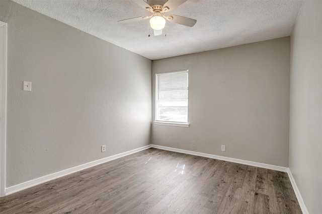 1909 Balla Way, Grand Prairie, TX 75051 - unfurnished room featuring a textured ceiling, wood finished floors, a ceiling fan, and baseboards