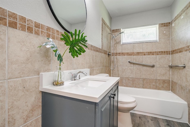 1909 Balla Way, Grand Prairie, TX 75051 - bathroom featuring toilet, tub / shower combination, wood finished floors, vanity, and tile walls