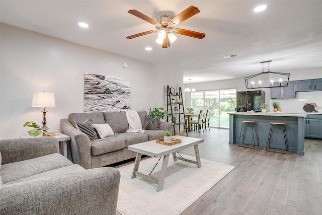 1909 Balla Way, Grand Prairie, TX 75051 - living room with a chandelier, ceiling fan, light wood finished floors, and recessed lighting
