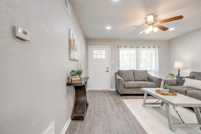 1909 Balla Way, Grand Prairie, TX 75051 - living area featuring light wood-style flooring, ceiling fan, baseboards, a textured wall, and recessed lighting