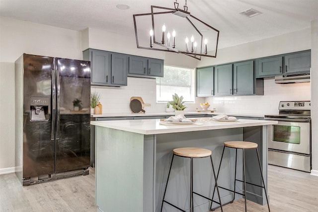 1909 Balla Way, Grand Prairie, TX 75051 - kitchen with black fridge, electric stove, light wood finished floors, and light countertops