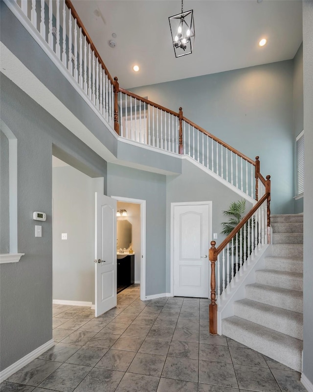 1635 Southwestern Dr, Allen, TX 75013 - stairs featuring a high ceiling, baseboards, a chandelier, and recessed lighting