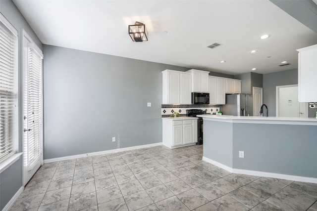 1635 Southwestern Dr, Allen, TX 75013 - kitchen featuring black appliances, backsplash, white cabinetry, a sink, and light countertops