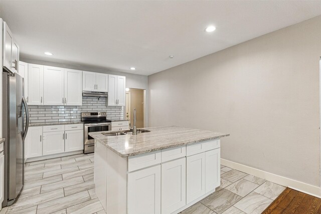 318 S Montreal Ave, Dallas, TX 75208 - kitchen with appliances with stainless steel finishes, under cabinet range hood, a sink, a center island with sink, and white cabinetry