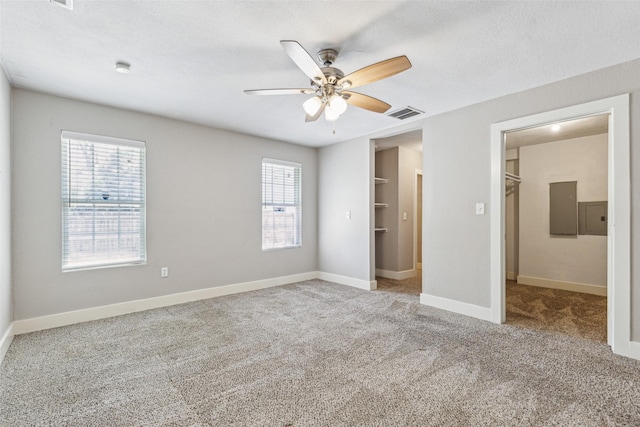 318 S Montreal Ave, Dallas, TX 75208 - unfurnished bedroom featuring a walk in closet, electric panel, carpet, and a closet