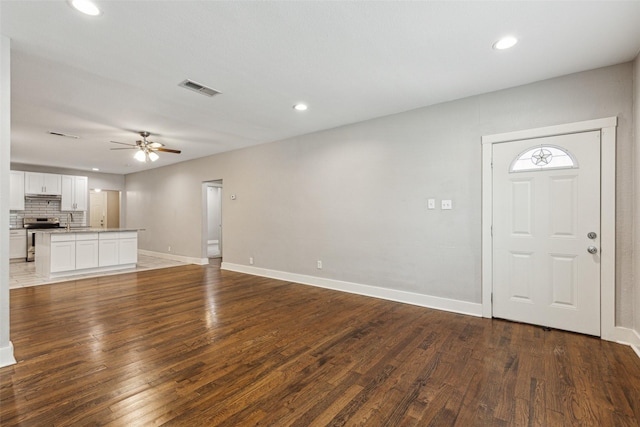 318 S Montreal Ave, Dallas, TX 75208 - unfurnished living room with ceiling fan, recessed lighting, baseboards, wood finished floors, and a sink