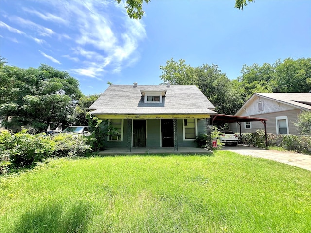 2214 Pearl Ave, Fort Worth, TX 76164 - bungalow-style home with driveway, covered porch, a front yard, and an attached carport