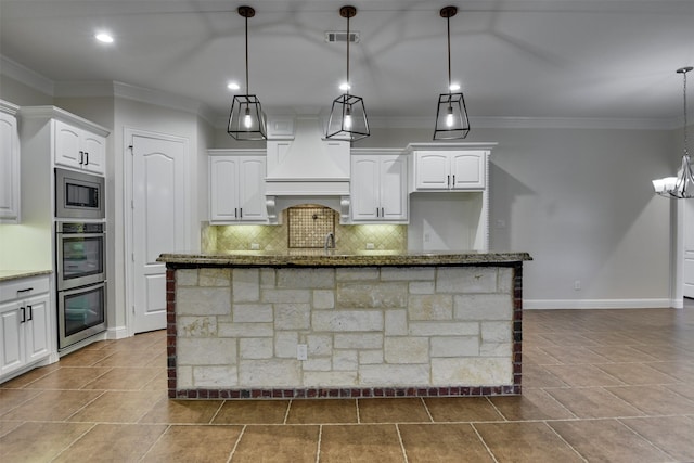 6520 Stone Creek Dr, North Richland Hills, TX 76182 - kitchen with appliances with stainless steel finishes, dark stone countertops, tasteful backsplash, white cabinetry, and ornamental molding