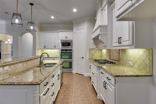 6520 Stone Creek Dr, North Richland Hills, TX 76182 - kitchen featuring a sink, appliances with stainless steel finishes, arched walkways, white cabinets, and custom range hood