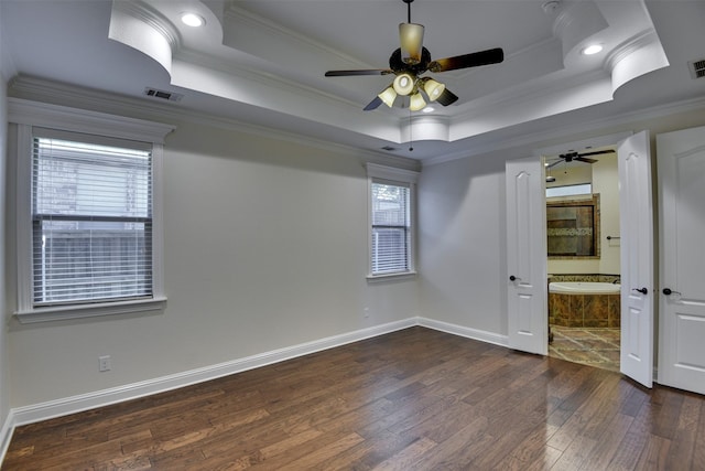 6520 Stone Creek Dr, North Richland Hills, TX 76182 - unfurnished bedroom with dark wood finished floors, multiple windows, a raised ceiling, baseboards, and crown molding