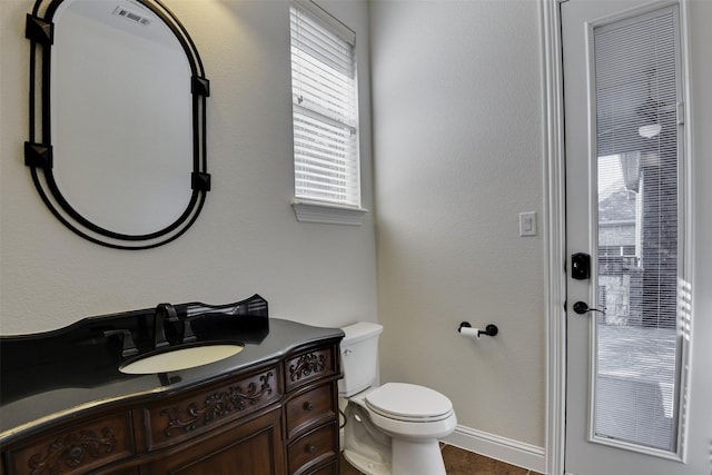 6520 Stone Creek Dr, North Richland Hills, TX 76182 - half bathroom featuring vanity, toilet, baseboards, and tile patterned flooring