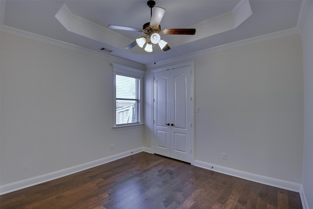 6520 Stone Creek Dr, North Richland Hills, TX 76182 - empty room featuring a raised ceiling, dark wood finished floors, ceiling fan, baseboards, and ornamental molding
