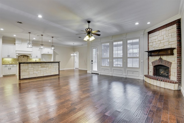 6520 Stone Creek Dr, North Richland Hills, TX 76182 - unfurnished living room featuring a fireplace, a ceiling fan, ornamental molding, recessed lighting, and dark wood finished floors