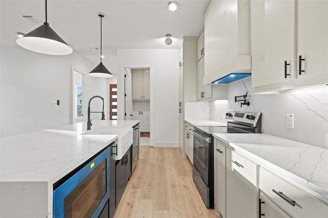 1218 Gannon Ln, Desoto, TX 75115 - kitchen featuring stainless steel appliances, a sink, premium range hood, white cabinetry, and light wood finished floors