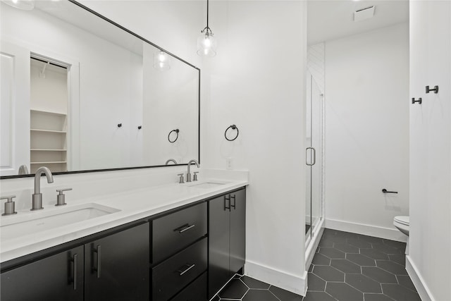 1218 Gannon Ln, Desoto, TX 75115 - full bathroom with double vanity, a stall shower, toilet, tile patterned floors, and baseboards