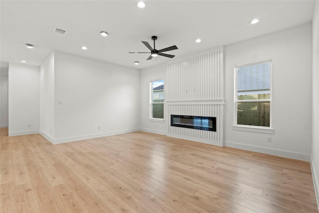 1218 Gannon Ln, Desoto, TX 75115 - unfurnished living room with a ceiling fan, a fireplace, light wood-style flooring, recessed lighting, and baseboards
