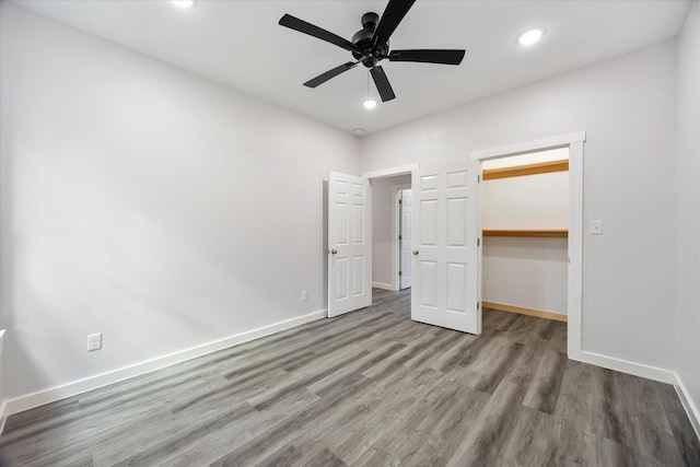 108 E Locust, Campbell, TX 75422 - unfurnished bedroom with a spacious closet, wood finished floors, baseboards, recessed lighting, and a closet