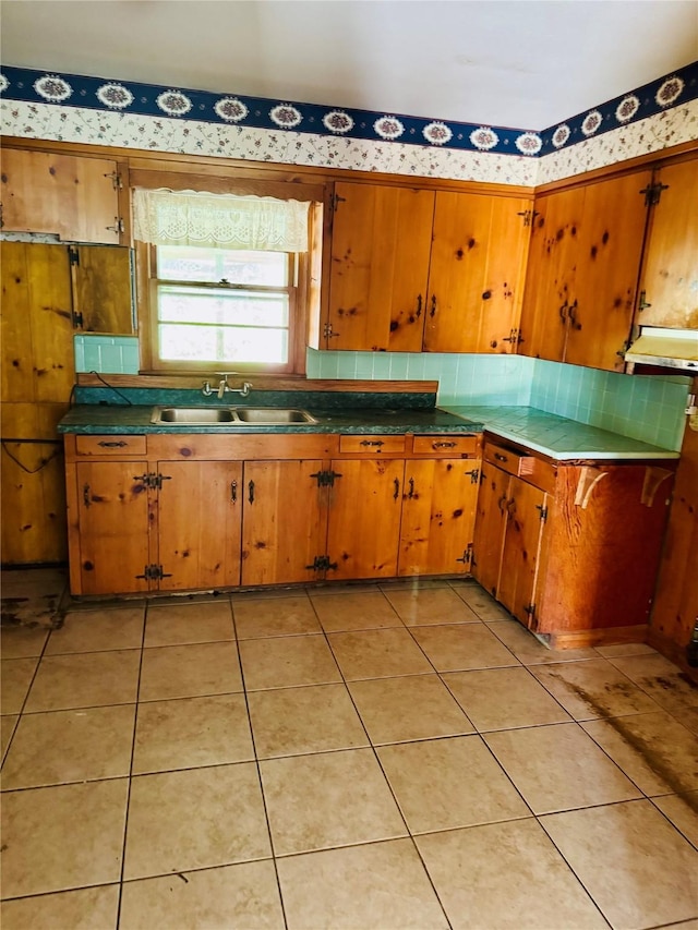 2505 Ormond Pl, Bossier City, LA 71111 - kitchen featuring a sink, brown cabinets, and wallpapered walls