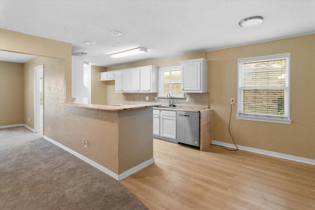 207 Mcmurry Ave, Duncanville, TX 75116 - kitchen with dishwasher, white cabinets, light countertops, and a peninsula
