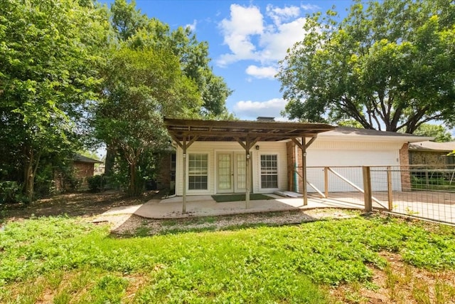 207 Mcmurry Ave, Duncanville, TX 75116 - back of house featuring french doors, a garage, driveway, a patio area, and a pergola