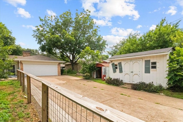 207 Mcmurry Ave, Duncanville, TX 75116 - single story home featuring a garage, a chimney, and an outbuilding