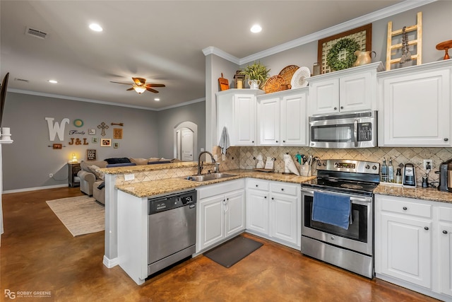 181 Bent Tree Loop, Haughton, LA 71037 - kitchen with appliances with stainless steel finishes, a sink, finished concrete flooring, open floor plan, and backsplash