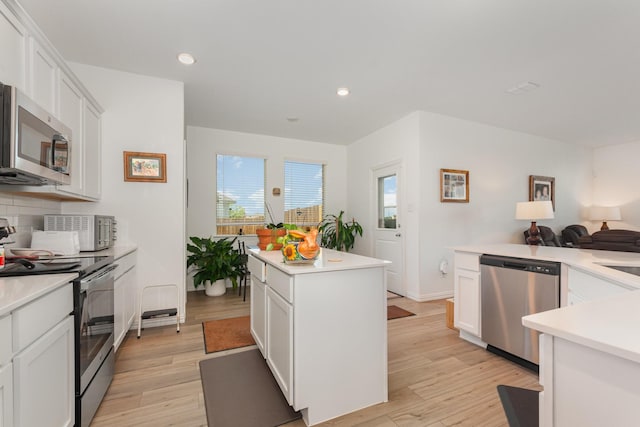 5201 Rockrose Ln, Princeton, TX 75407 - kitchen with appliances with stainless steel finishes, a kitchen island, light countertops, light wood-style flooring, and recessed lighting