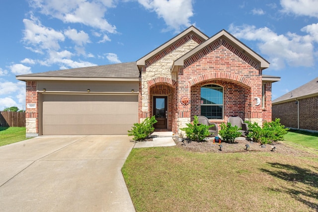 5201 Rockrose Ln, Princeton, TX 75407 - french country inspired facade with brick siding, driveway, an attached garage, and stone siding