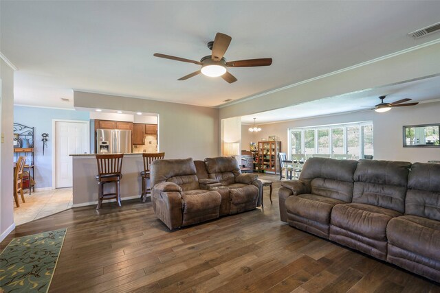 6710 Eastview Dr, Sachse, TX 75048 - living room with ceiling fan, a chandelier, hardwood / wood-style flooring, and ornamental molding