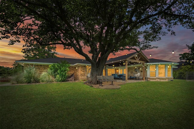 6710 Eastview Dr, Sachse, TX 75048 - rear view of house featuring a yard