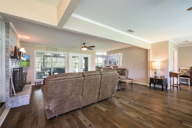 6710 Eastview Dr, Sachse, TX 75048 - living area with dark wood finished floors, a ceiling fan, crown molding, a brick fireplace, and baseboards