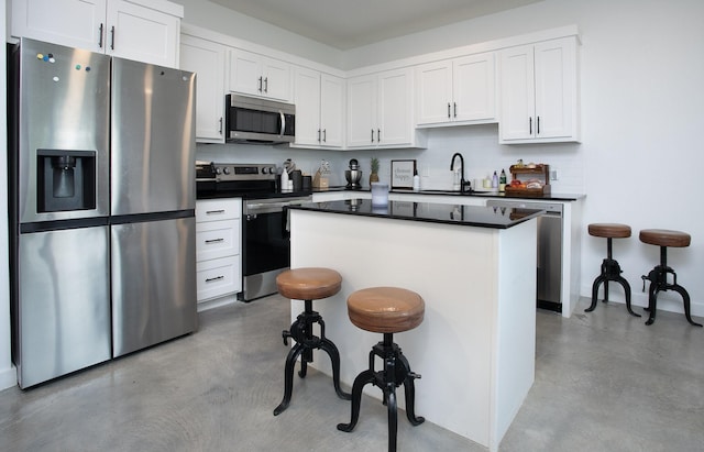 18747 Fm 2493, Flint, TX 75762 - kitchen with appliances with stainless steel finishes, a sink, concrete flooring, a center island, and white cabinetry