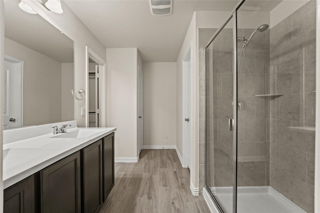 906 Silverbell St, Princeton, TX 75407 - bathroom featuring a stall shower, wood finished floors, and vanity